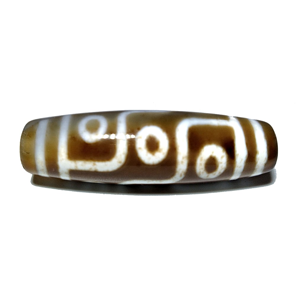 SINO-TIBETAN AGATE DZI BEAD 9 EYES 48MM: THE SINO-TIBETAN AGATE DZI BEAD IS FEATURES 9 EYES. IT IS 48MM LONG AND FEATURES PATINA FROM AGE. PROPERTY OF A FLORIDA COLLECTOR. WE COMBINE/PROVIDE IN-HOUSE SHIPPING.