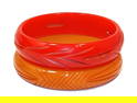 LOT OF 2 VINTAGE CARVED BAKELITE BANGLES BRACELETS IN RED AND YELLOW