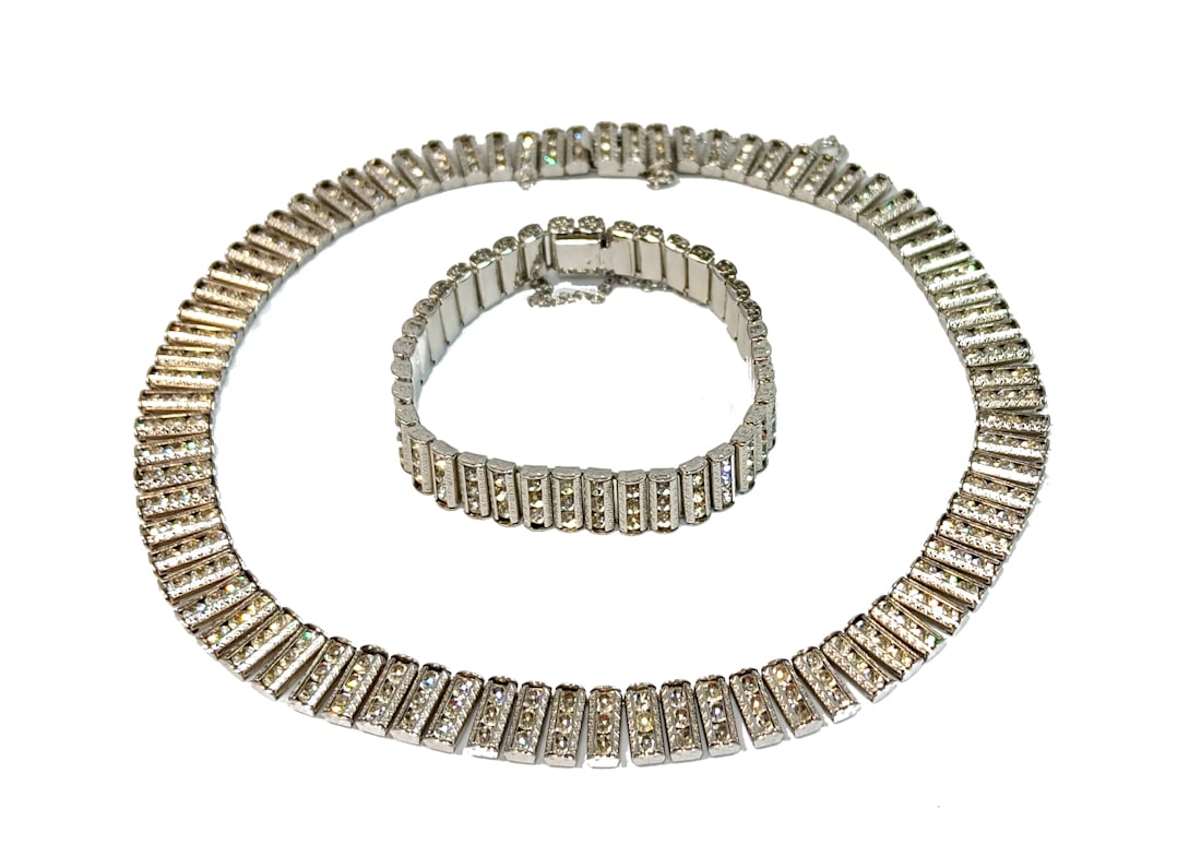 A FINE ART DECO CHANNEL SET RHINESTONE NECKLACE AND BRACELET SET: THIS LOT INCLUDES A FINE ART DECO CHANNEL SET RHINESTONE NECKLACE AND BRACELET SET, IN GREAT CONDITION. THE NECKLACE IS 16" LONG AND THE BRACELET IS 7" LONG. WE PROVIDE FREE IN-HOUSE SHIPPING WITHIN T