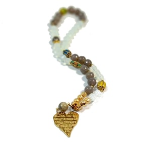 A NECKLACE OF FACETED CHALCEDONY ENAMEL AND A PRAYER 20"