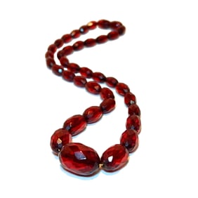 A FINE ANTIQUE FACETED AMBER NECKLACE 15"