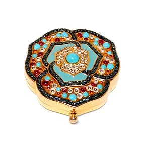 A VINTAGE ESTEE LAUDER LIMITED EDITION JEWELED FLOWER COMPACT WITH POWDER & MIRROR