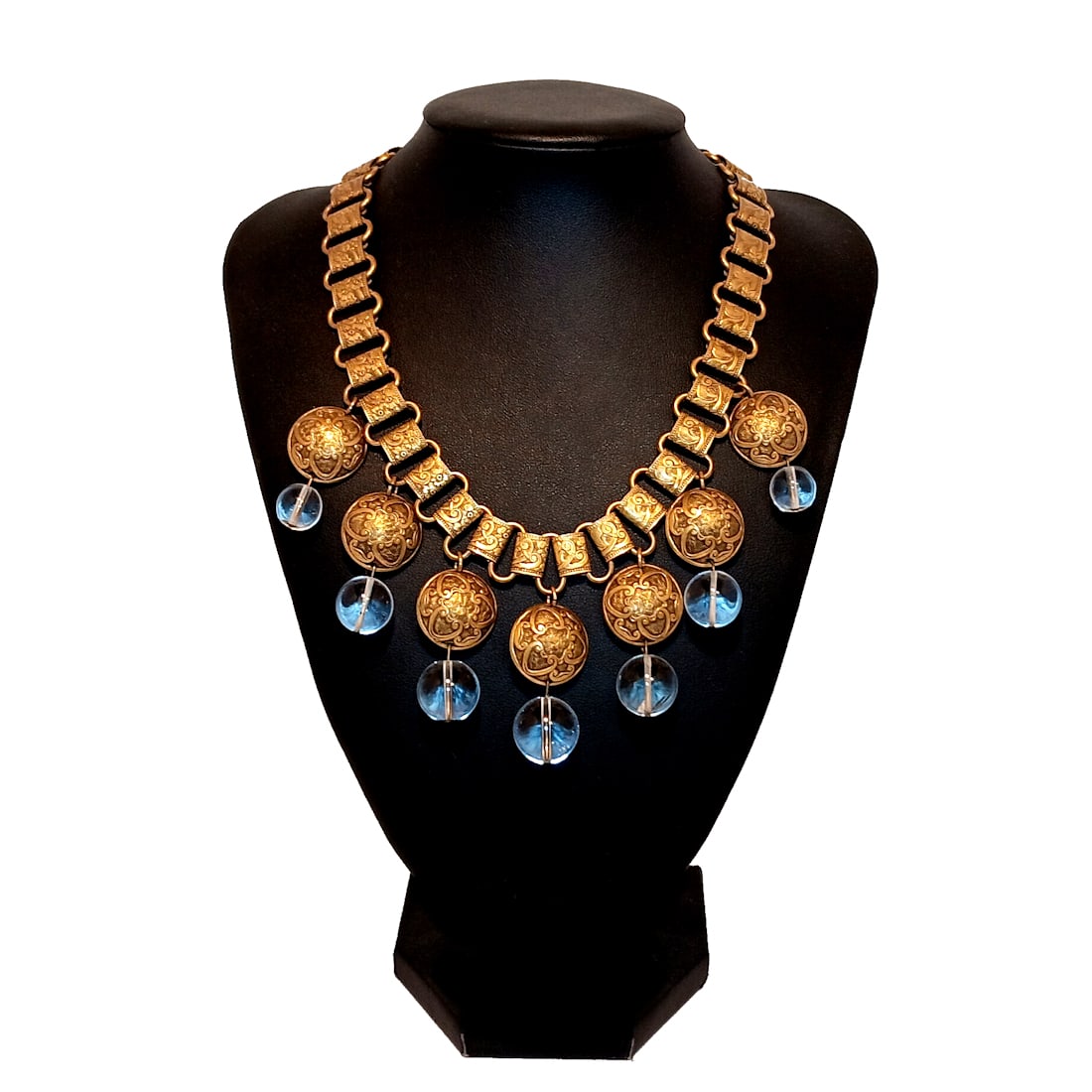 ANTIQUE "POOL OF LIGHT" ROCK CRYSTAL & BRASS BOOK CHAIN NECKLACE 15" C. 1900-1920: RARE ANTIQUE NECKLACE FEATURING ROCK CRYSTAL"POOLS OF LIGHT" BEADS (LARGEST 17MM) SUSPENDED FROM EMBOSSED REPOUSSE BRASS DISCS ON AN ORNATE BOOK CHAIN. MEASURES 15" LONG. A CAPTIVATING EXAMPLE OF EARL
