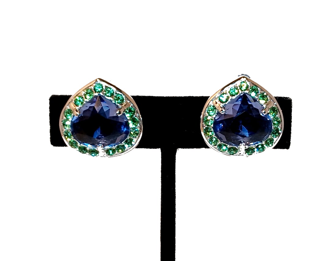 VINTAGE SWAROVSKI CLIP-ON EARRINGS WITH BLUE TEARDROP CRYSTALS & GREEN ACCENTS SIGNED: STUNNING VINTAGE SWAROVSKI EARRINGS FEATURING LARGE FACETED TEARDROP-SHAPED BLUE CRYSTALS SURROUNDED BY VIBRANT GREEN RHINESTONES. SIGNED ON THE CLIP BACKS. ELEGANT HEART-LIKE FORM WITH SILVER-TONE ME