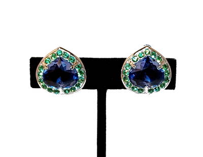 VINTAGE SWAROVSKI CLIP-ON EARRINGS WITH BLUE TEARDROP CRYSTALS & GREEN ACCENTS SIGNED: STUNNING VINTAGE SWAROVSKI EARRINGS FEATURING LARGE FACETED TEARDROP-SHAPED BLUE CRYSTALS SURROUNDED BY VIBRANT GREEN RHINESTONES. SIGNED ON THE CLIP BACKS. ELEGANT HEART-LIKE FORM WITH SILVER-TONE