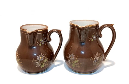 PAIR OF RUSTIC FRENCH BROWN FLORAL CREAM PITCHERS LATE 19TH CENTURY