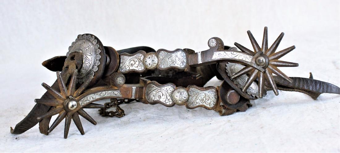 Visalia Stock Saddle Co. Spurs: Exceptional large spurs with elongated 3" shanks, finely engraved silver panels and domes, classic flat strap buttons, and huge 12 point rowels. Topped off by wonderful and uncommon full spelled out m
