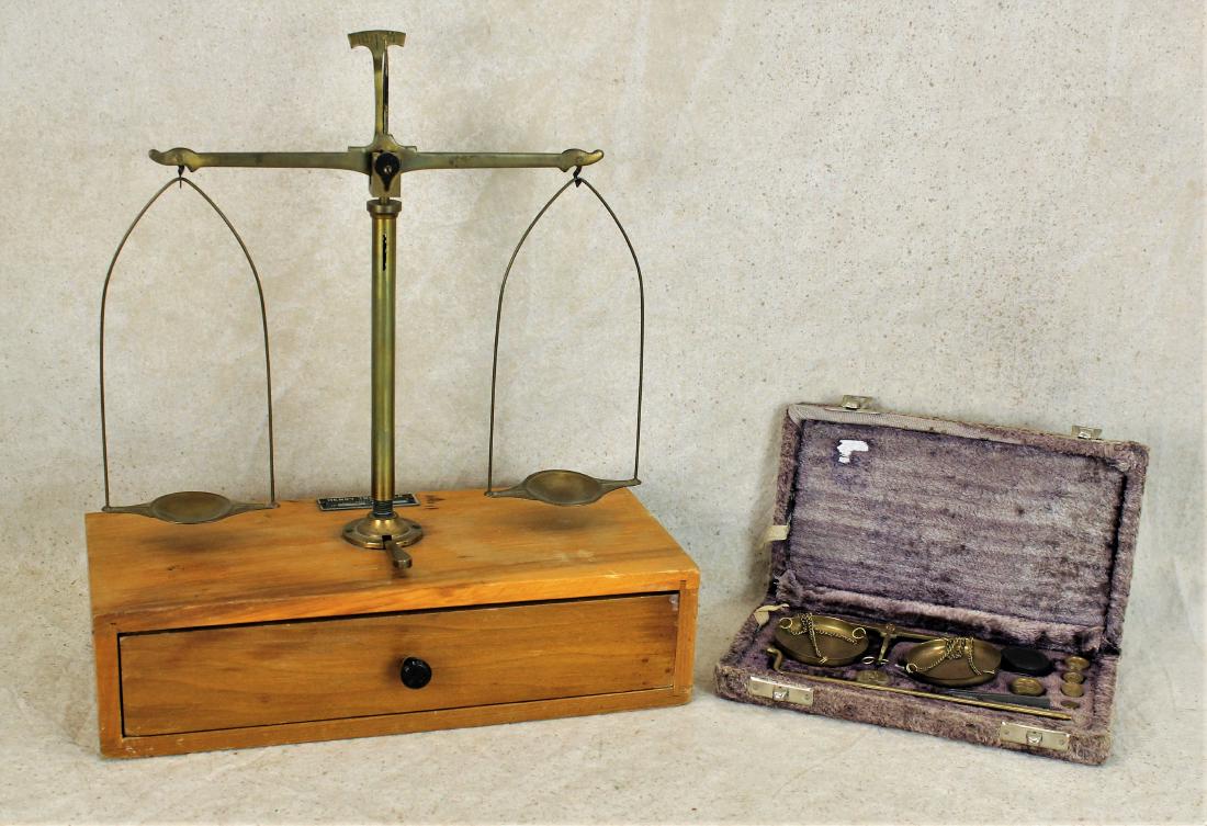 Lot of Antique Scales: Two sets antique scales; 1) traveling scale in velvet covered traveling box, complete with weights. 2) Table top scale with wooden drawer cabinet and accessories.