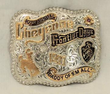 Cheyenne Frontier Days Buckle: Artistic commemorative western belt buckle with scalloped edges, finely engraved silver with gold overlayed Wyoming bucking horse, "1997 Cheyenne Frontier Days", and numbered #2/100. Category: