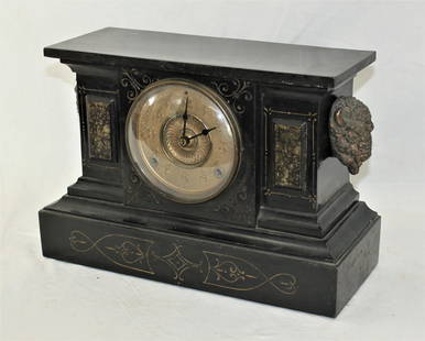 Buffalo Mantle Clock: Very attractive antique mantle clock with a finely designed cabinet using a large clock face and set off with three dimensional molded buffalo heads. Category: Furniture