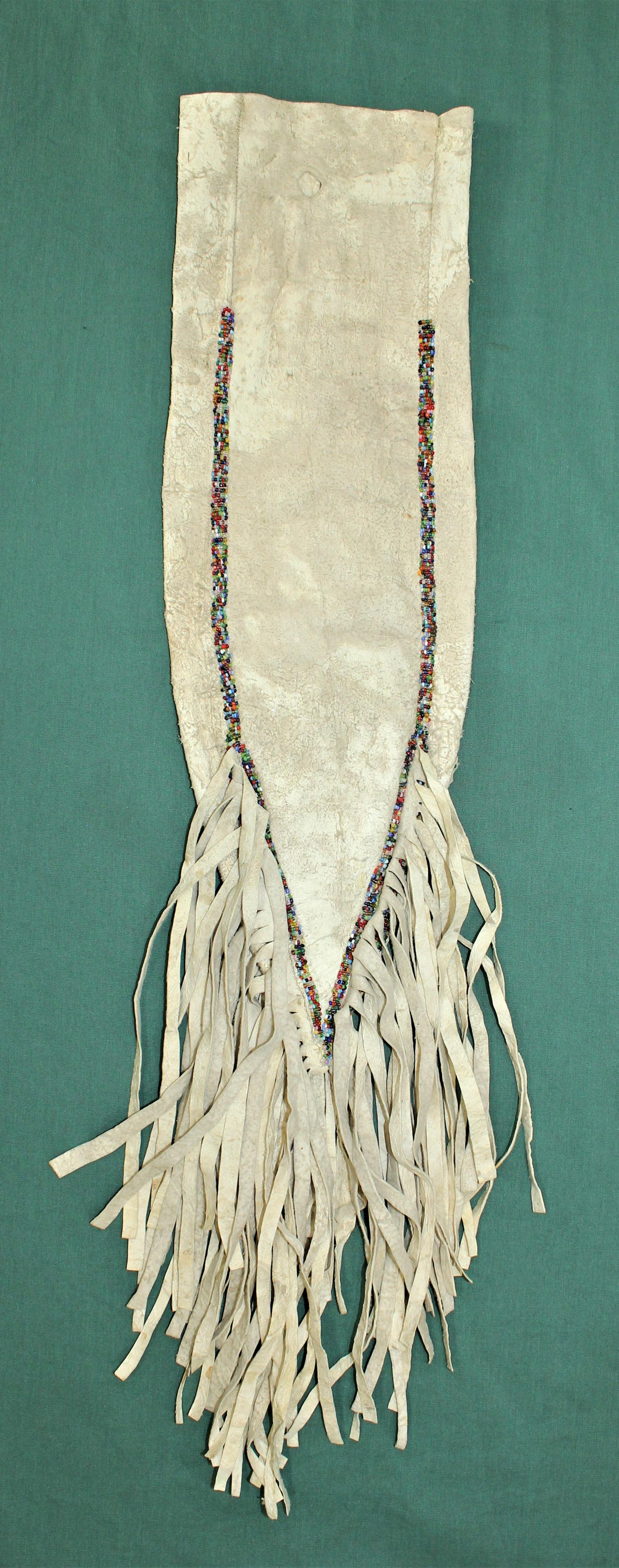 Sioux Beaded Hide Tobacco Bag: Turn of the Century elongated bag with wonderful fringe and salt and pepper beadwork. Measuring 37" in length.