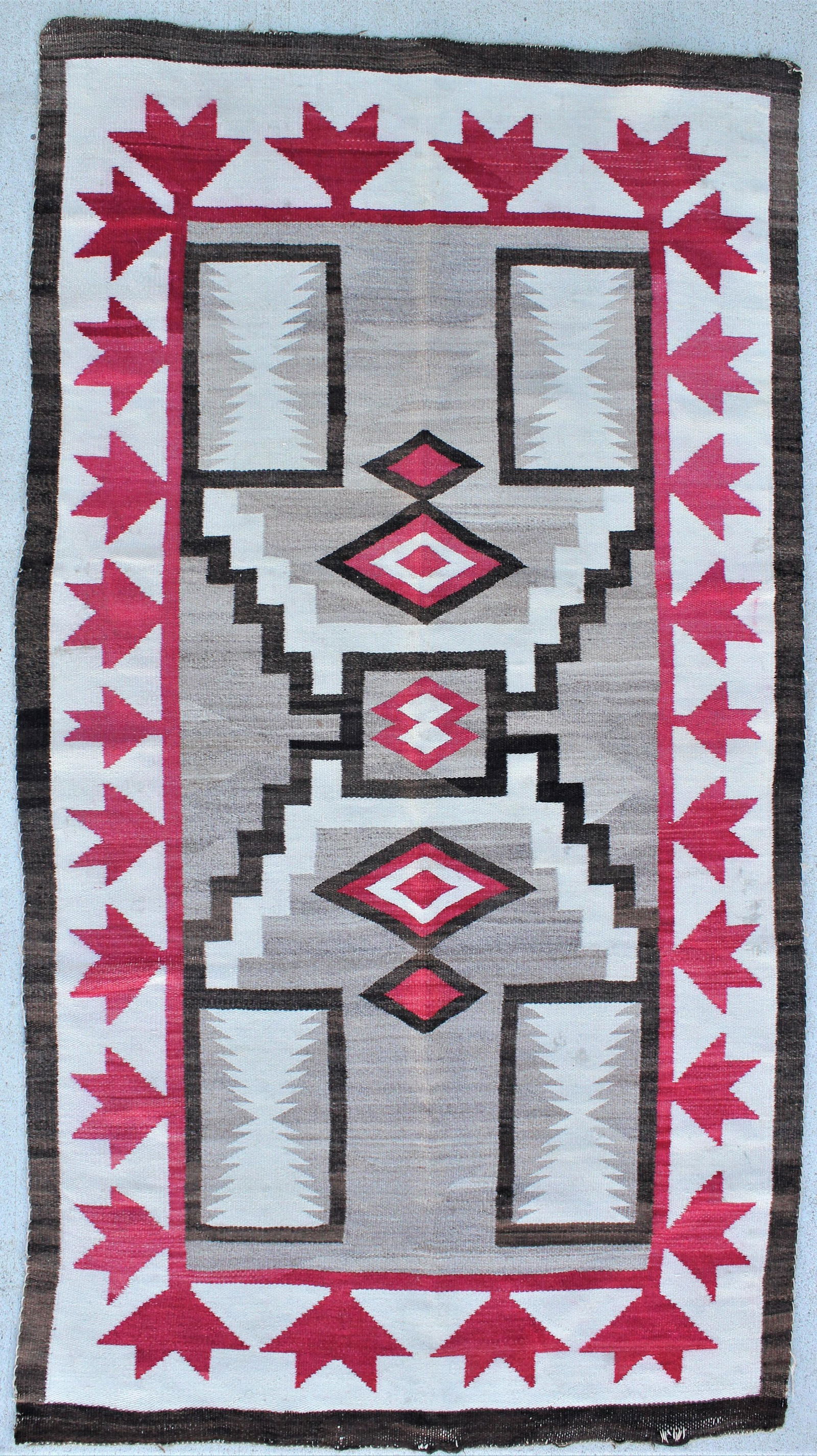 Large Navajo Weaving: Pleasing 1930's Storm pattern rug with great color and style, measuring 42"x 76".