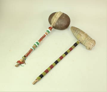 Native American War Clubs: Two Northern Plains beaded stone head war clubs, displaying early beaded hafts and one with a detail carved effigy stone head.