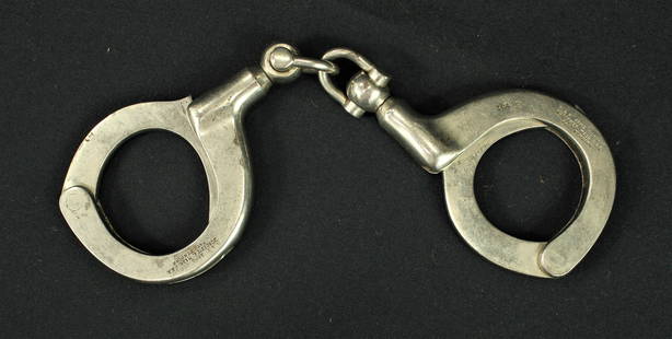 H & R Handcuffs: Great pair of nickel finish handcuffs made by the gun manufacturer, Harrington and Richardson, showing excellent.