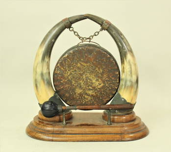 Western Desktop Gong: A nice desk-top hand hammered gong, held by longhorns, on a quartersawn oak base. Showing great patina and complete with mallet.