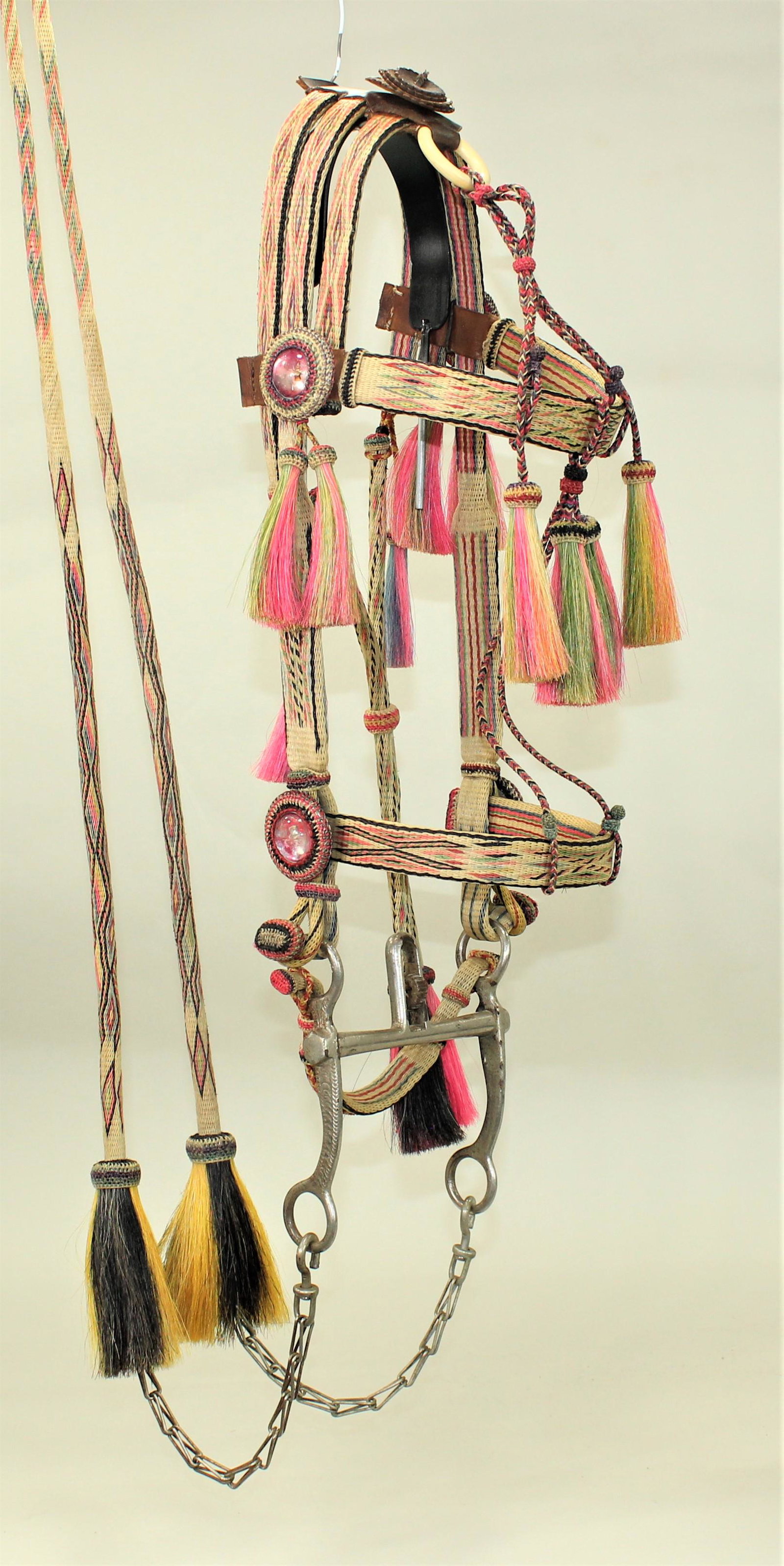 Montana Penitentiary Horsehair Bridle: A very scarce Deer Lodge prison bridle made with a bold mixture of pink and green background, incorporated with seven other colors throughout, creating a true masterpiece of art, focusing on a never s