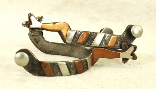 Gal Leg Spurs: A Texas style pair of single mounted spurs with two-tone overlay and 5 point star rowels, finished by Don P maker markings.