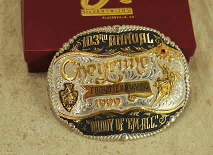 Cheyenne Frontier Days Buckle: An artistically designed 1999 commemorative belt buckle by Gist, with bull riding scene. Numbered 2 of 100 and including its box.