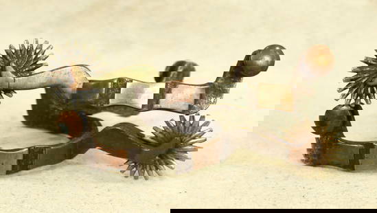 Gal Leg Spurs: A large pair of double mounted lady leg spurs with full copper and silver overlay, scalloped heelbands, and large multi-point rowels.