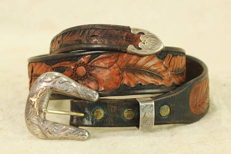 Silver Ranger Buckle Set: A beautifully made custom belt with two-tone carving, accented by an attractive silver ranger set with gold steerhead, maker marked Western Silversmiths. In good condition and measuring 34" in total