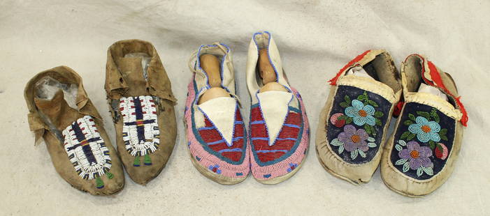 Grouping of Moccasins: A lot of three pair of Blackfoot Indian moccasins, all in adult sizes, with well done beadwork. Showing nice afge and condition. Circa early 1900's.