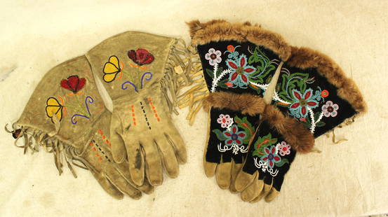 Grouping of Beaded Gauntlets: Two pair of Blackfoot Indian beaded gloves with floral patterns and fringe, with original condition and showing wear.