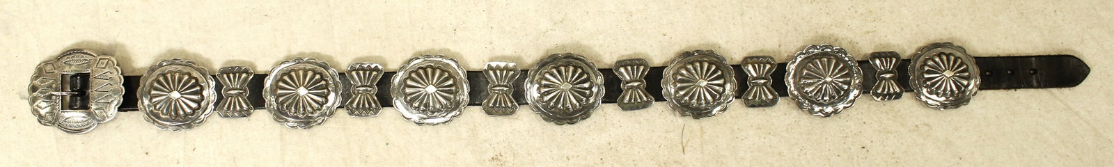 Navajo Silver Concho Belt: A nicely presenting Native American silver concho belt with attractive three dimensional scalloped 2" conchos, in excellent condition, measuring 31" in length.