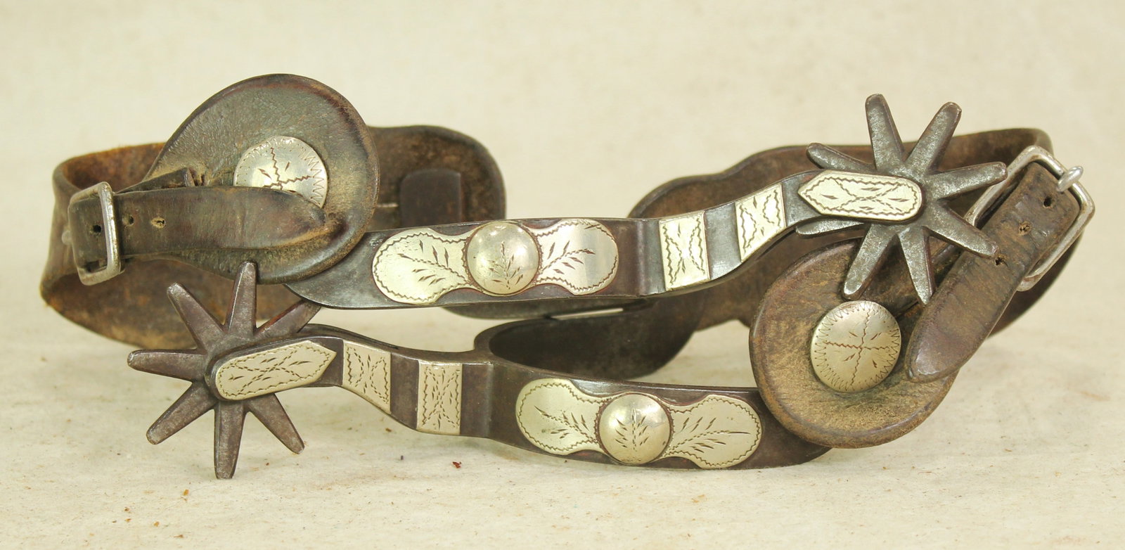 Rare Crockett Spurs: A beautifully presenting pair of inside marked pattern #129 spurs, noted as "The Southern", double mounted with early Crockett engraved silver, and original straps.