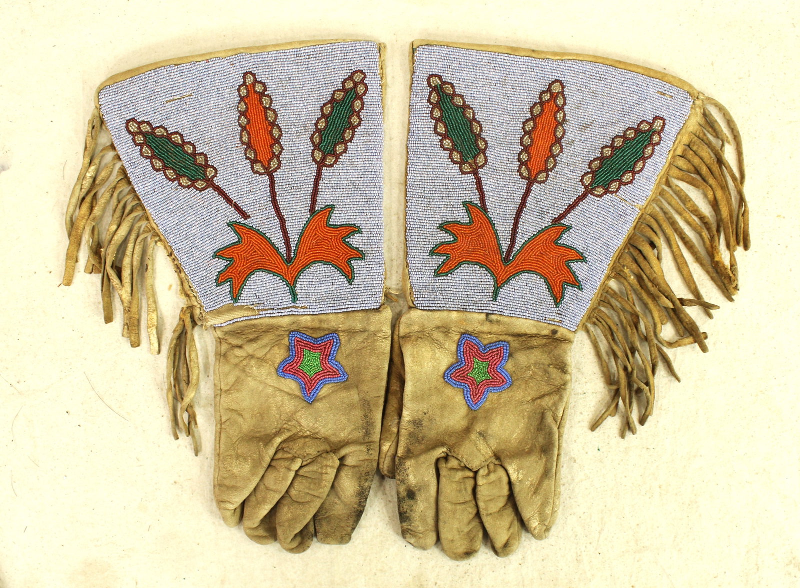 Plateau Beaded Gauntlets: A great pair of Native American made gauntlets, fully beaded, with uncommon lavender colored background and accenting fringe.
