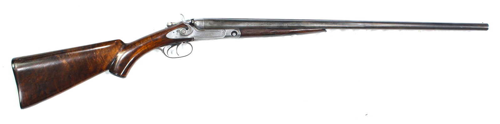 Parker Shotgun: Vintage antique Parker Hammer 12 Ga, shotgun. Fine damascus twist steel barrels with exposed hammers and double triggers. 28" Barrels choked full & Mod. Varnished checkered pistol grip walnut stocks w