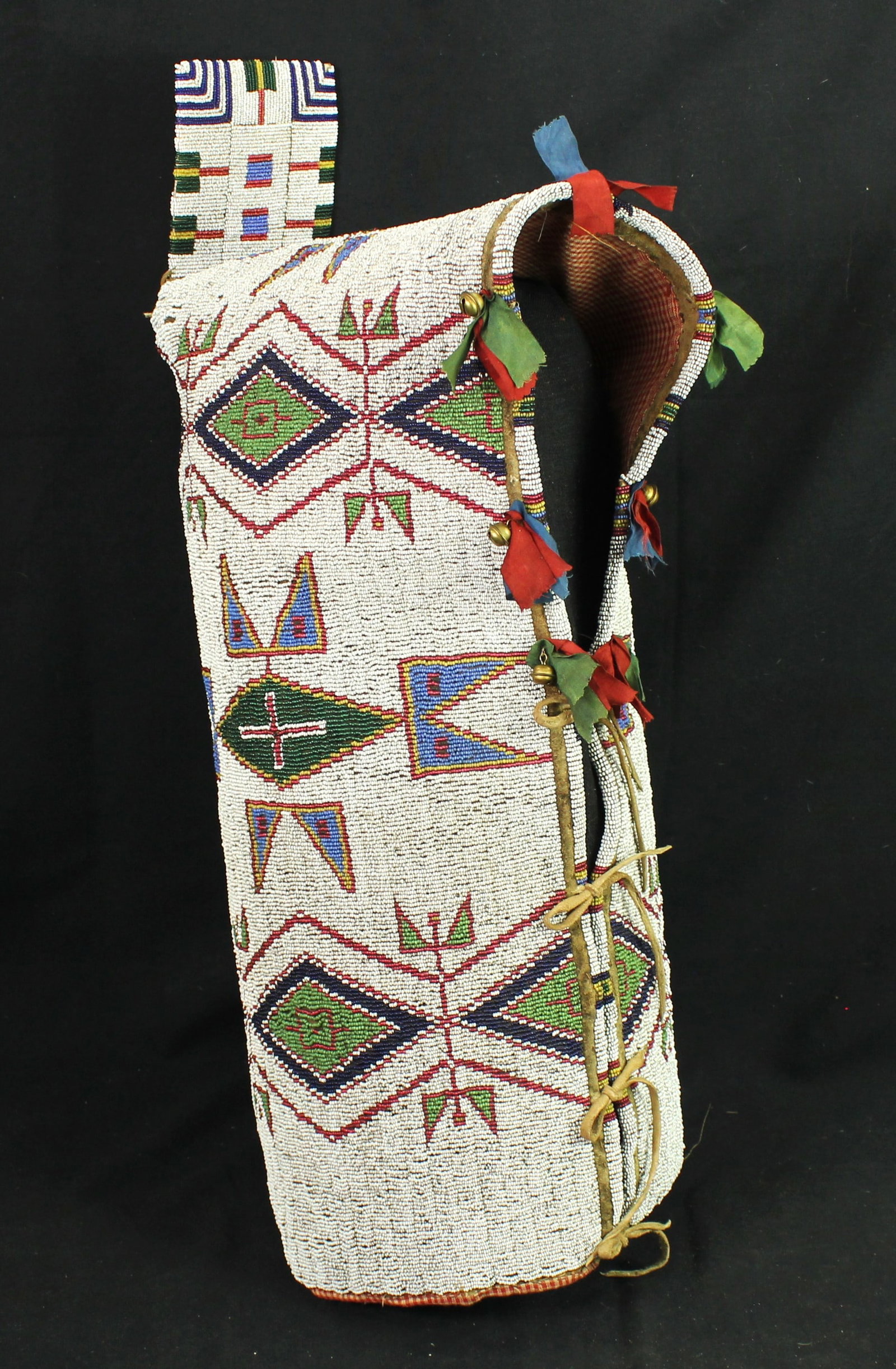 Sioux Beaded Cradle Cover: An outstanding 19th Century Plains Indian fully beaded cradle cover with uncommonly high detailed beadwork, with amazing apple green, cobalt blue and red white heart geometrics on a white baground, an