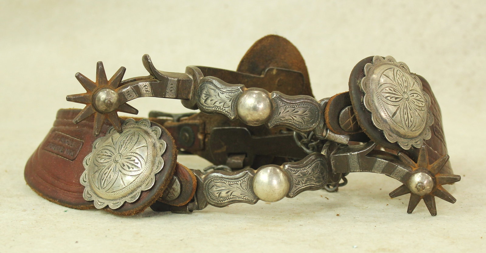 Buerman Silver Spurs: A classy pair of single mounted Buerman's with silver striped dropshanks and Cheyenne Wyoming marked concho straps.