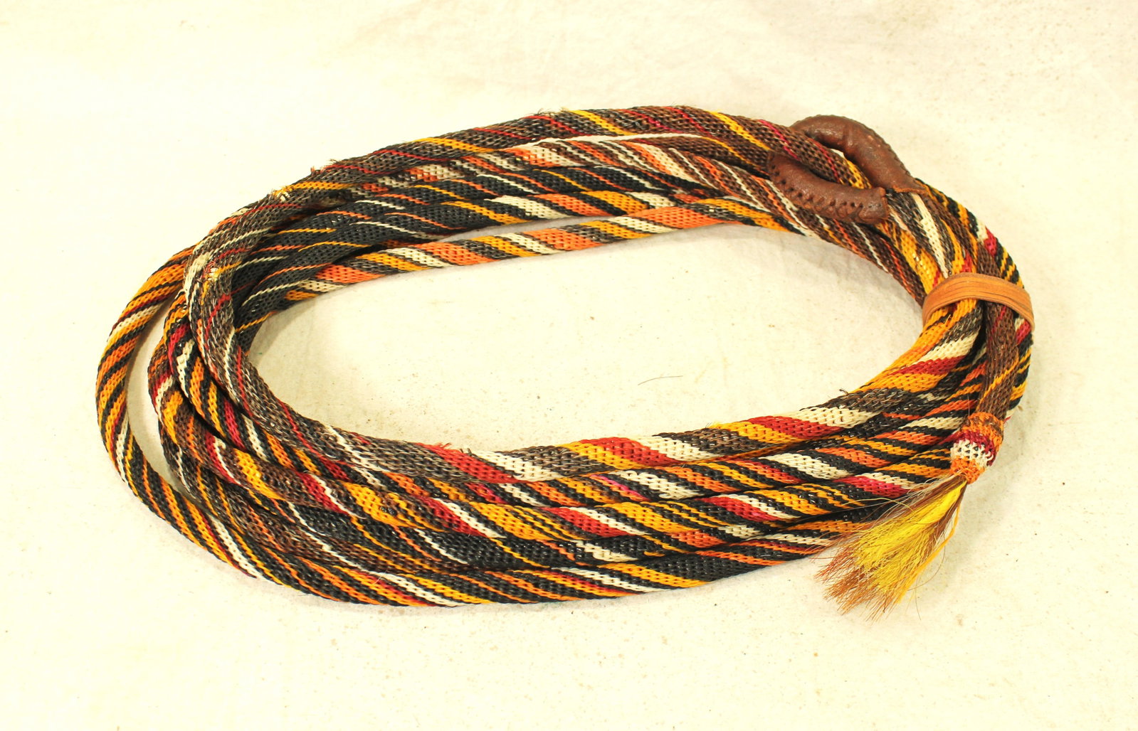 Deerlodge Prison Horsehair Rope: A colorful Deerlodge prison horsehair hitched rope with muliple spiraling colors, a leather bound honda, and measuring approximately 18 feet long.