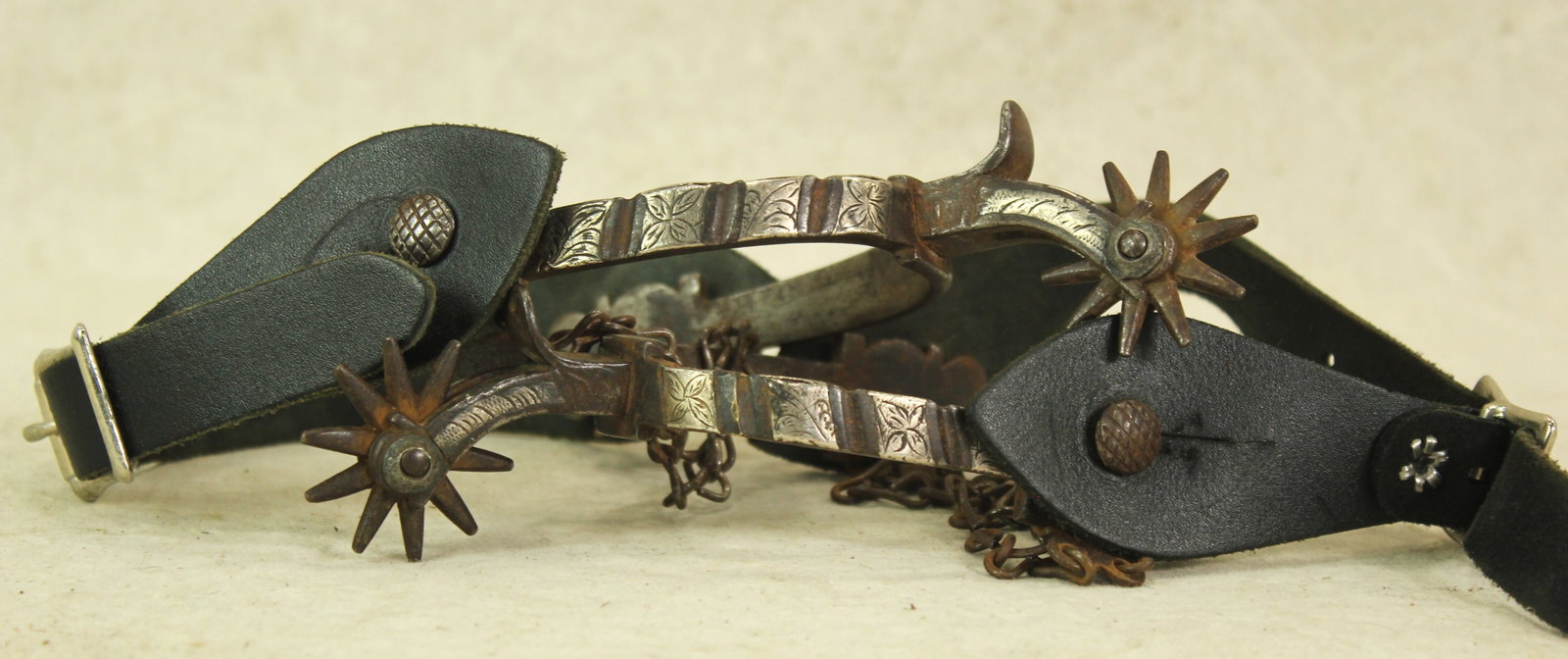 Buerman Silver Spurs: An extra early pair of single inlaid spurs with engraved silver bars, and deeply chased iron off sides. With nice condition and patina.