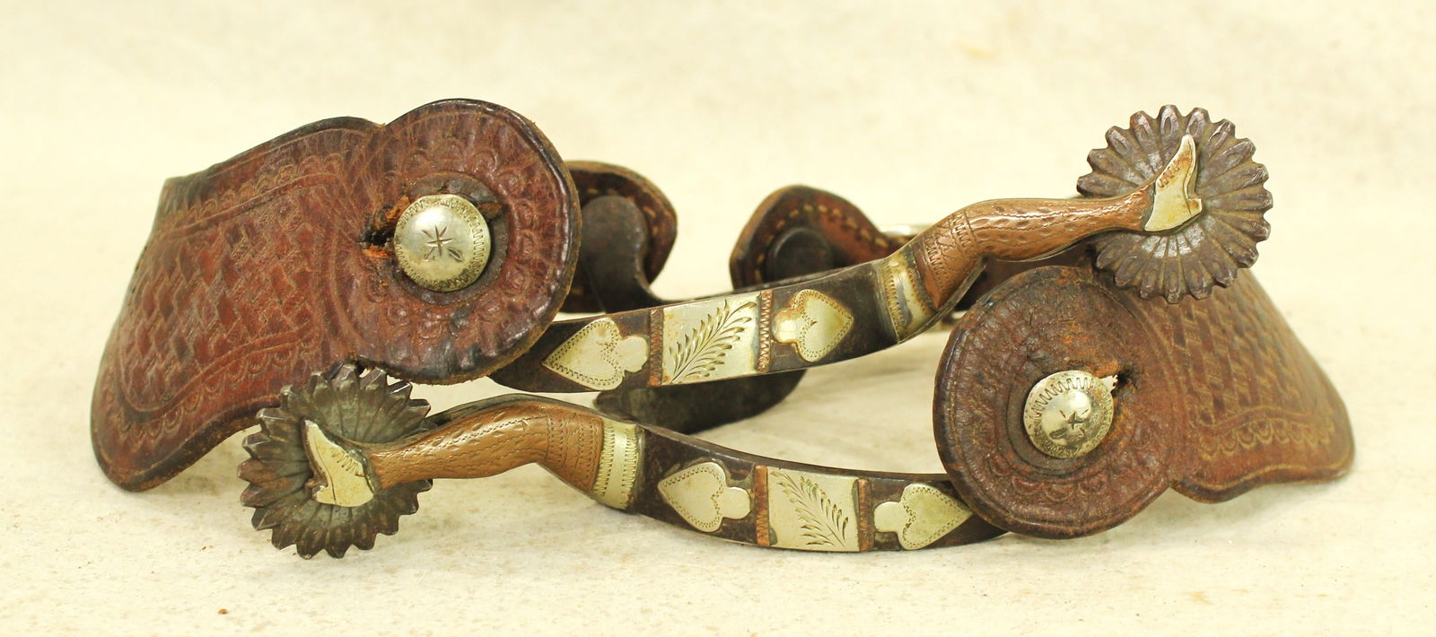 McChesney Lady Leg Spurs: A wonderful pair of double mounted #8 lady leg spurs with beautifully patinaed copper, with striking engraving and condition, finished by nice original straps.