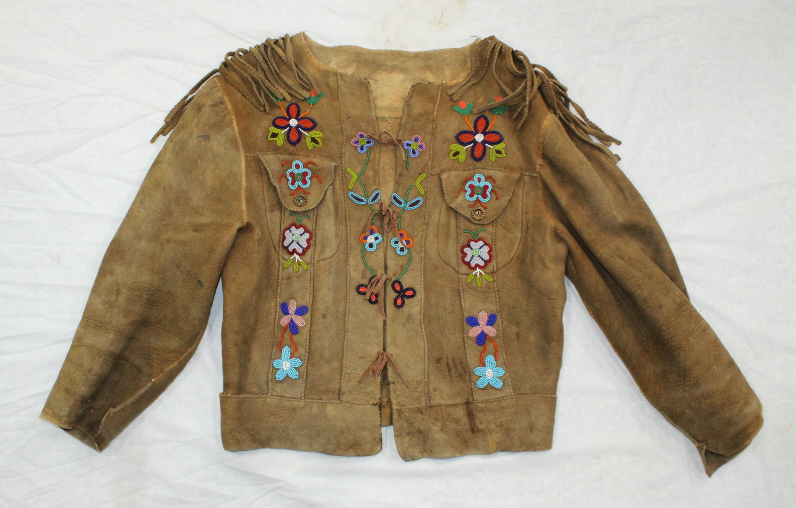 Blackfoot Indian Beaded Shirt: A Native American decoratively beaded moose hide shirt with a nice look and eye appeal.