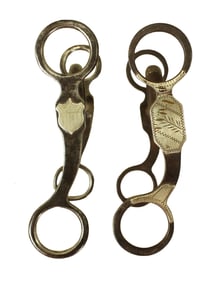 A pair of Texas style iron silver mounted grazing bits, one well marked Crockett, and a highly