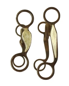 Two Texas style iron short shank grazing bits, one with leaf pattern and the other with the
