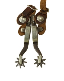 Vintage pair of single mounted Crockett spurs with large swinging buttons and ectra long shanks.