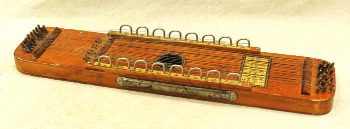 An early 1900's stringed instrument known as a Ukelin. Showing nice condition and color.