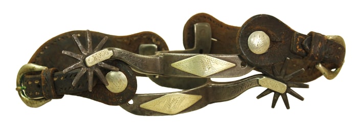 A nice pair of single mounted Texas style spurs with a diamond motif and original straps.