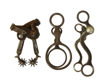 Gathring of three items which includes August Buerman iron spurs, iron globe bit and iron long shank