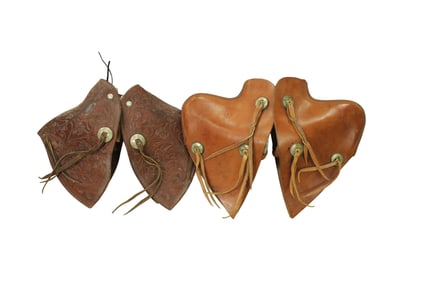 Two pairs of large saddle tapaderos, one 16" fully flower tooled and the other 17" with pronounced