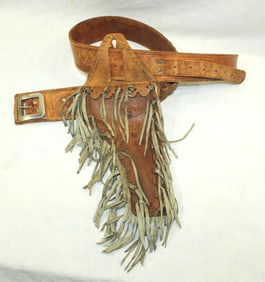 A great looking unmarked gun rig with a heavily fringed single action holster, along with a 2 1/2"