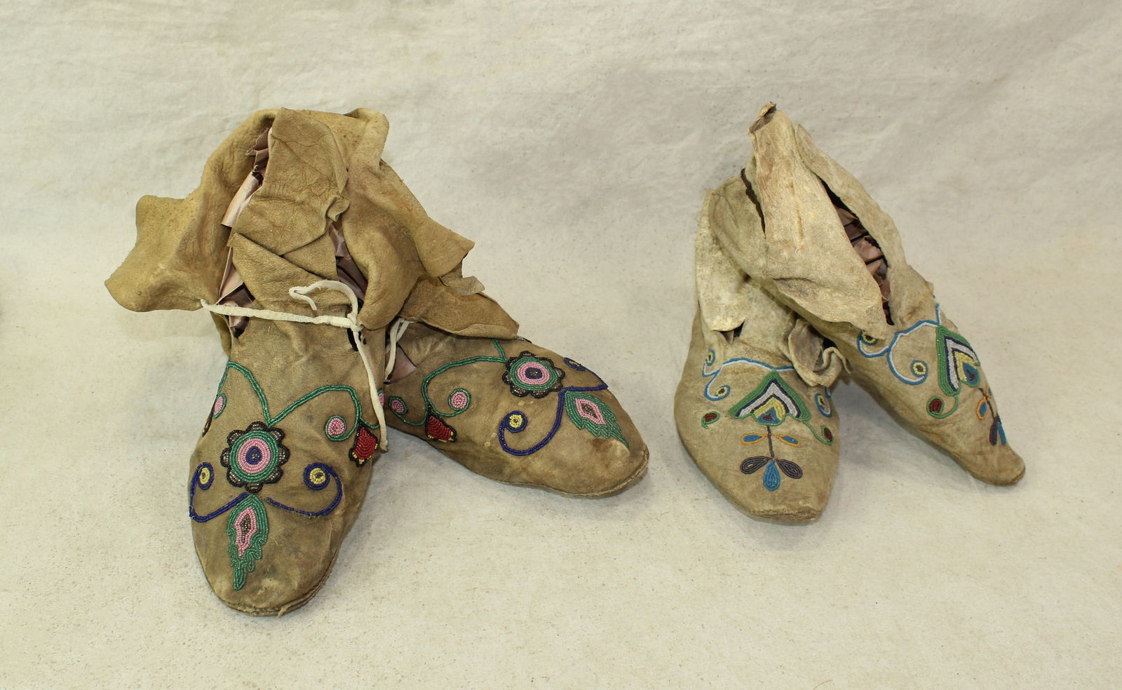 Two Pairs of Mocassins: Grouping of two pairs of American Indian moccasins, with detail seed beaded designs and nice condition.