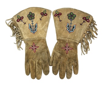 Plains Indian leather gloves with tiny seed bead floral pattern complimented with fringe.