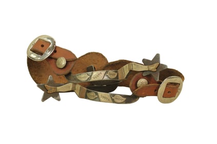 Well done pair of single mounted spurs in a two-tone lady leg pattern, and five point star rowels.