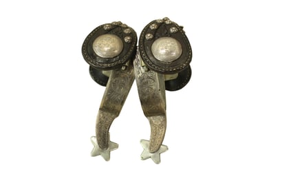 Striking pair of single mounted spurs with unique engraving pattern, and topped off with fantastic