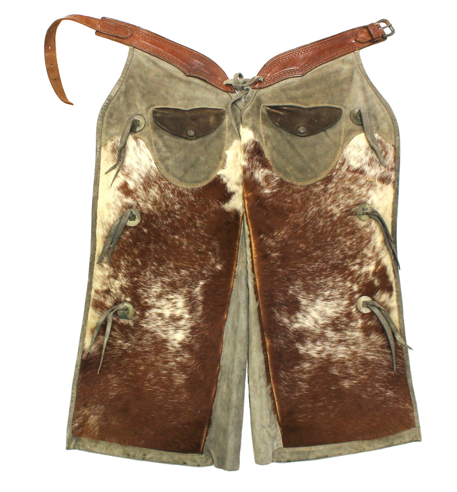 C.P. Shipley Shotgun Chaps: An interesting and attractive pair of very uncommon hair-on cowhide chaps with great bridle colored hair, pockets and tooled belt. Showing exceptional condition and measuring 30" in length.