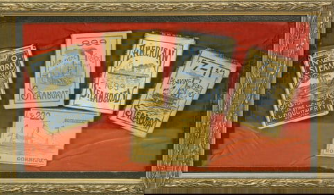 A framed display of a variety of five different antique display boxes of Steamboat playing cards.